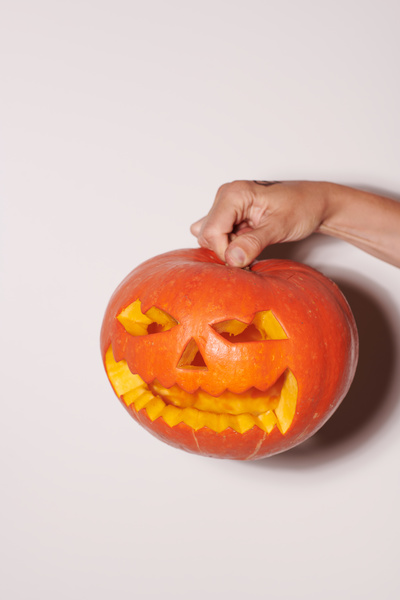 Human Hand Holds Halloween Pumpkin